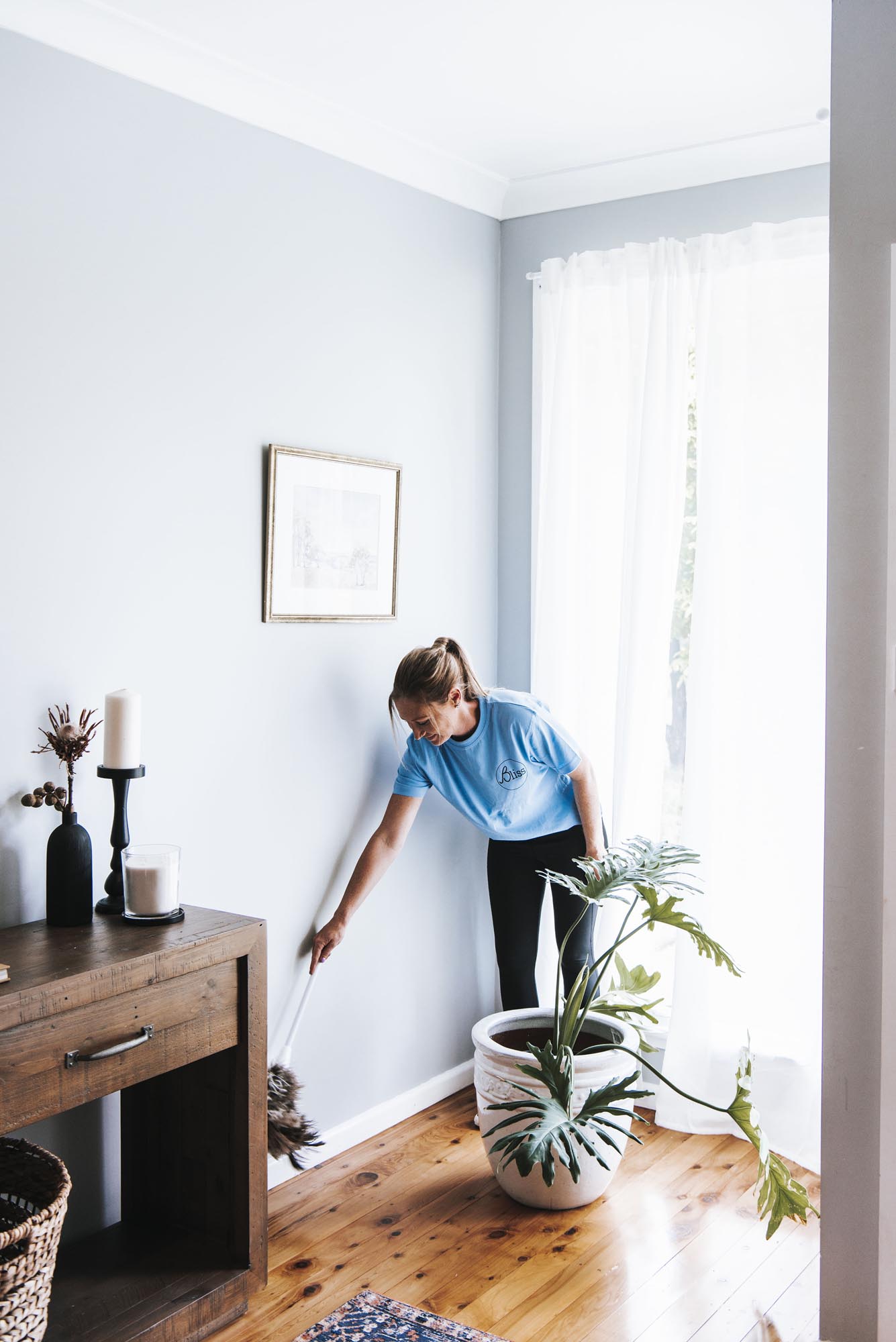 woman dusting table